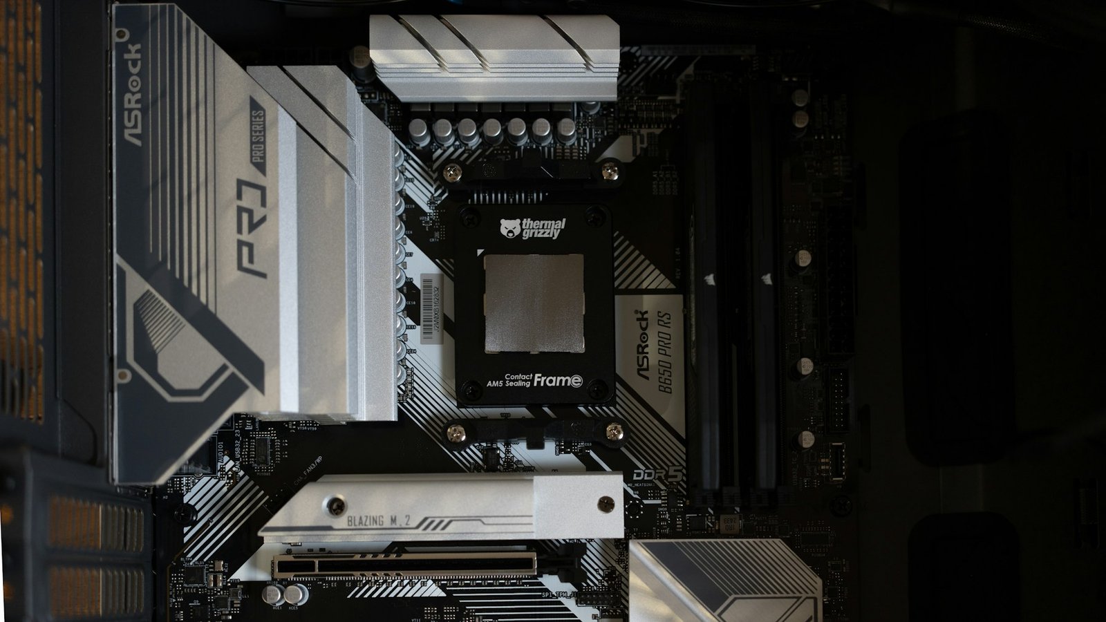 Computer motherboard with a black contact frame over the central processor